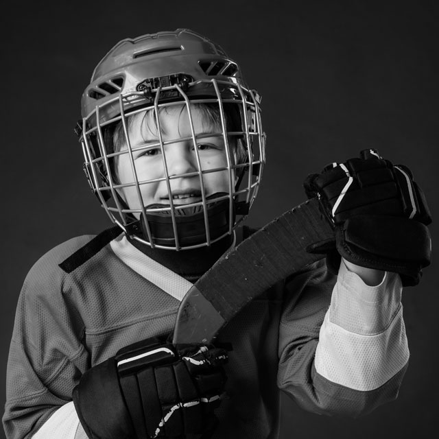 Young kid dressed to play hockey