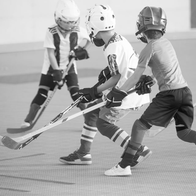Young players playing ball hockey